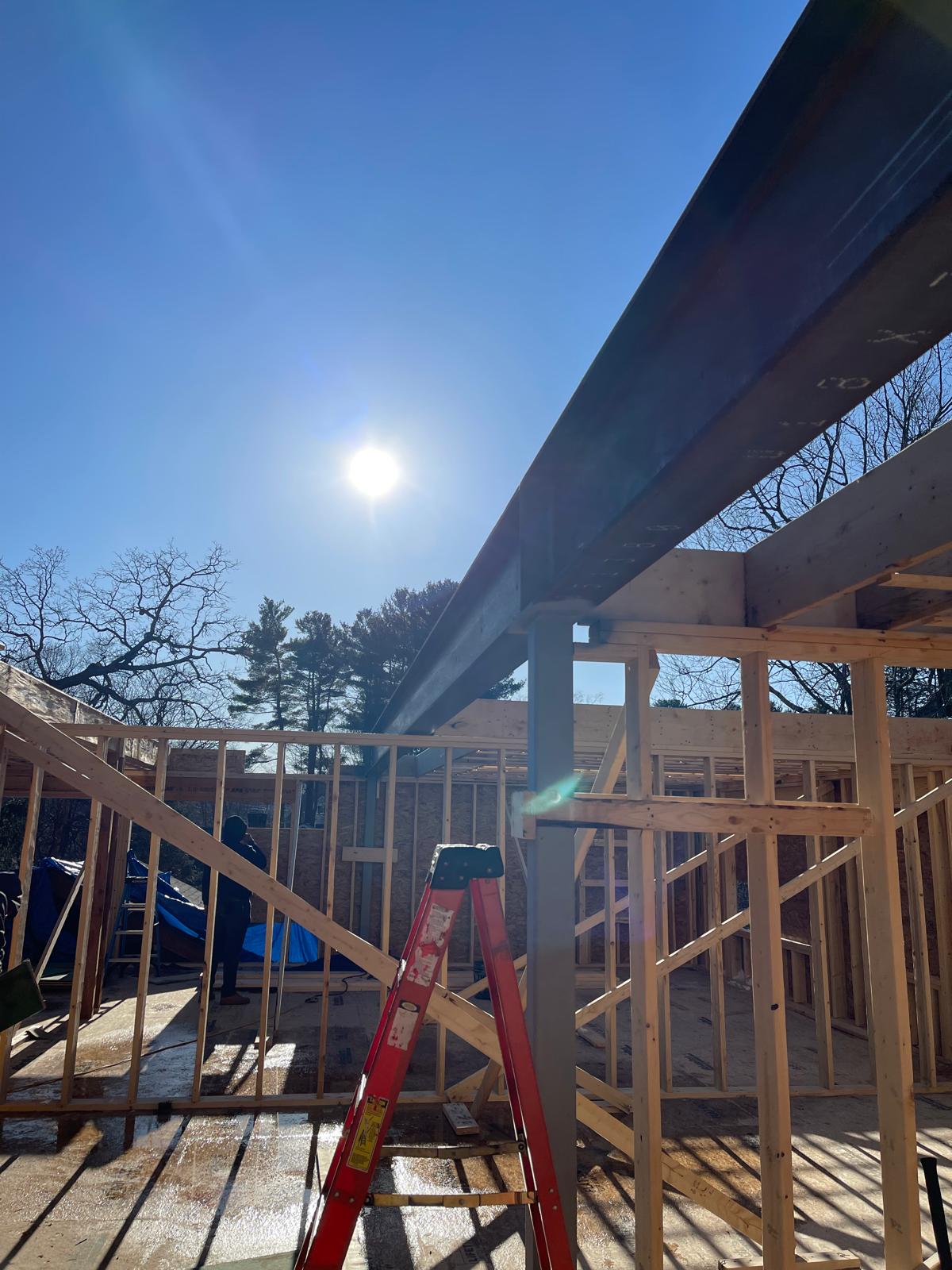 Steel beam installed above timber framing on an active project